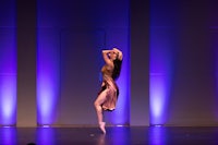 a woman in a pink dress is performing on stage